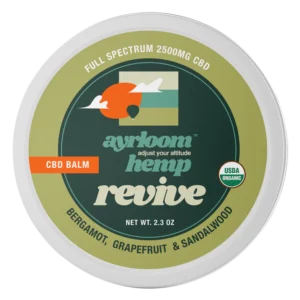 A small container of Ayrloom Revive Balm with bright citrus and earthy branding, highlighting bergamot, grapefruit, and sandalwood.