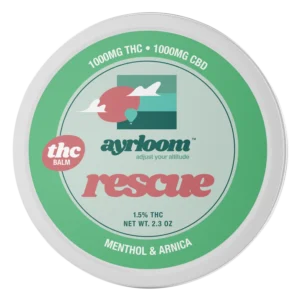 A small container of Ayrloom Rescue Balm with blue and white branding, highlighting menthol and arnica, positioned for easy application.